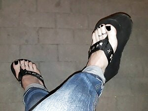 a crossdresser on a night walk walks around and tempts with his beautiful feet